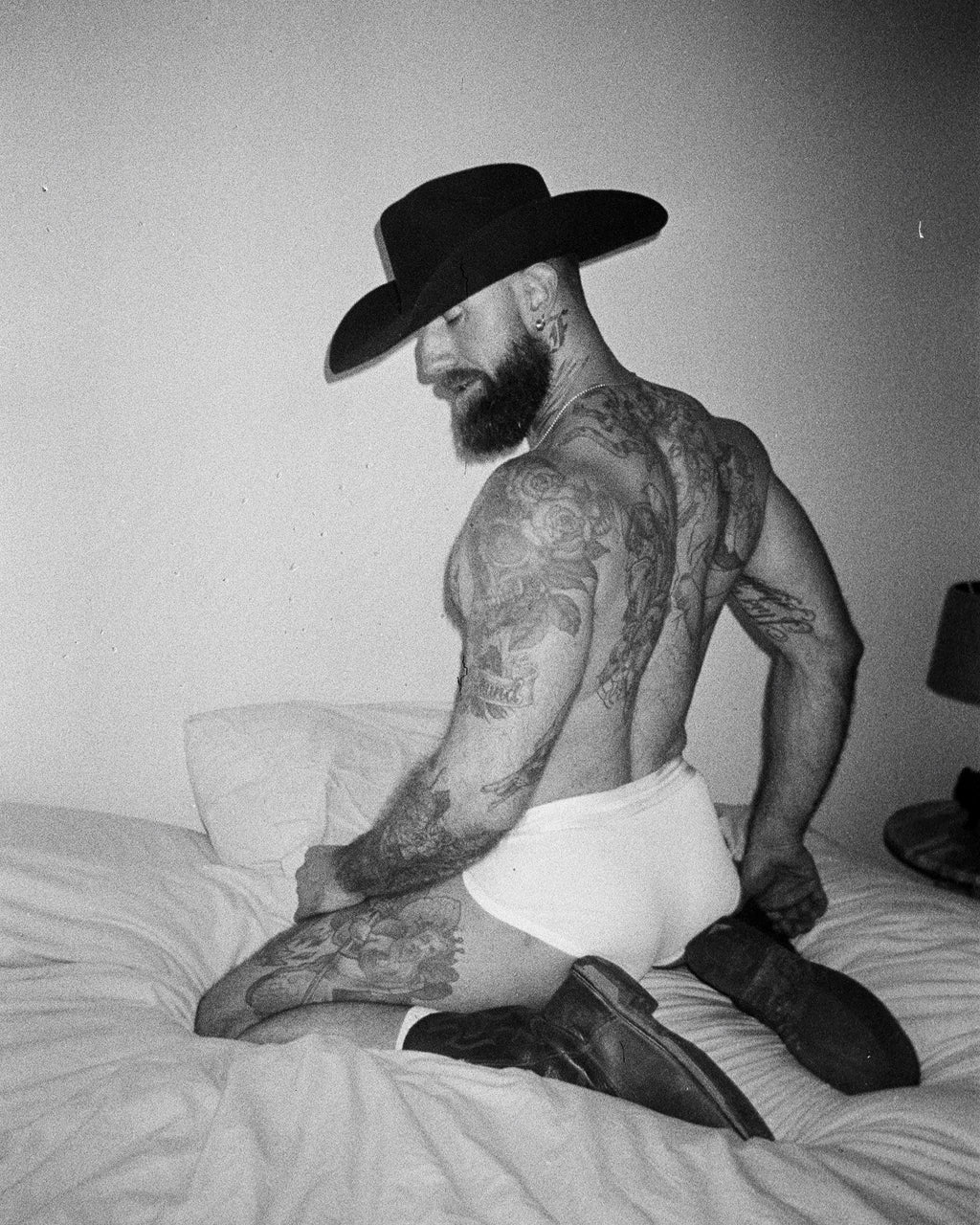 Miles Stewart, TroyDaniels_BootAndCowboyHatOnBed4_35mm, 2025